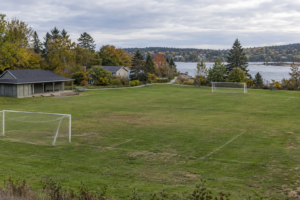 AI-generated view of fictional Northbank Field, its modest pavilion and public path, without the proposed lighting.